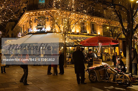 Roasted chestnut street seller outside Les Deux Magots Cafe and Restaurant, Boulevard St Germain, Paris, France