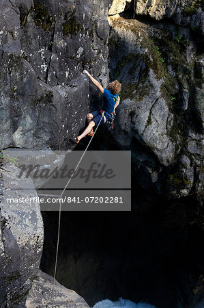 A climber tackles an overhang above Nairn Falls, near Pemberton, British Columbia, Canada, North America