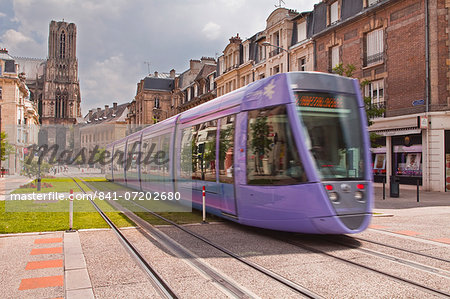 A tram passes in front of Notre Dame de Reims cathedral, Reims, Champagne-Ardenne, France, Europe