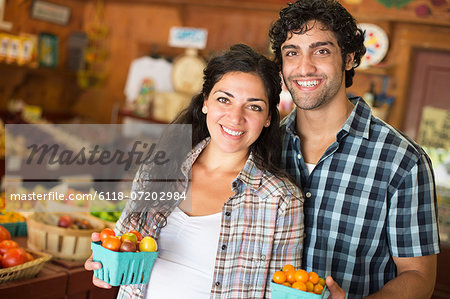 A farm growing and selling organic vegetables and fruit. A man and woman working together.