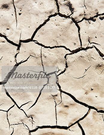 Cracked parched earth and baked mud on the ground. Drought.