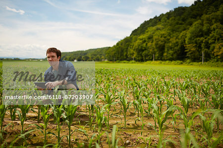 A farmer working in his fields in New York State, USA.