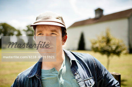 A man in a baseball cap on an organic farm in New York State.