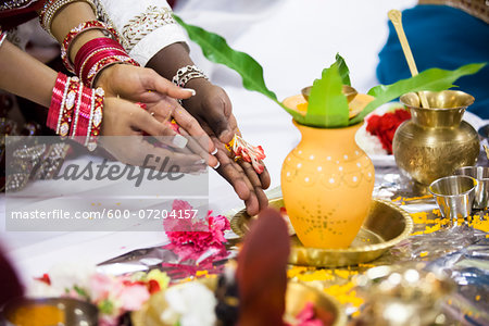 Close-up of Bride and Groom's Hands at Hindu Wedding Ceremony, Toronto, Ontario, Canada