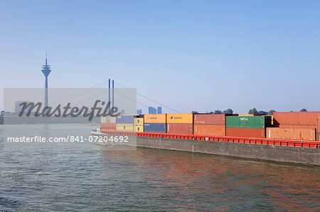 Container ship on the Rhine River, Rheinturm tower, Rheinkniebrucke bridge, Dusseldorf, North Rhine Westphalia, Germany, Europe