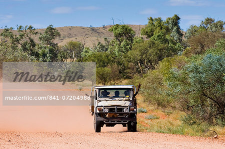 Aborigines in four-wheel-drive vehicle, Mereenie-Watarrka Road, Red Centre, Australia