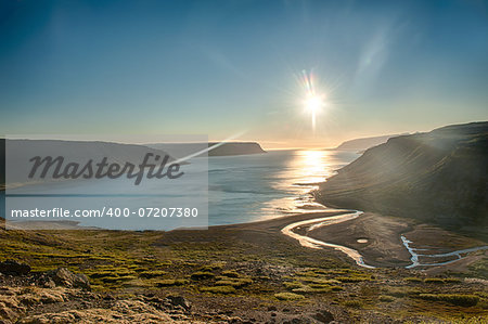 Sun is setting over the fjord on the Iceland