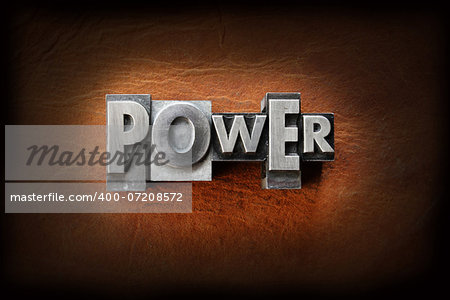 The word power made from vintage lead letterpress type on a leather background.