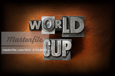 The words World Cup made from vintage lead letterpress type on a leather background.