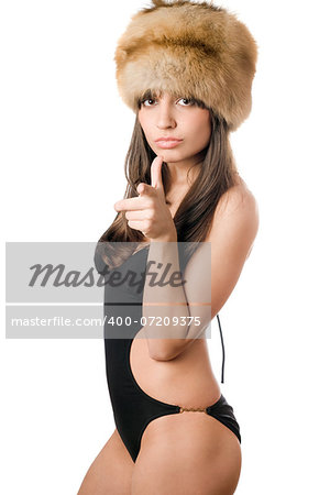 Young pretty caucasian woman in black swimsuit and fur-cap. Isolated