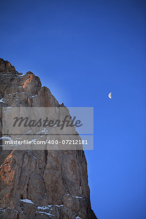 Rocks at early morning and blue sky with moon. Turkey, Central Taurus Mountains, Aladaglar (Anti-Taurus) view from plateau Edigel (Yedi Goller)