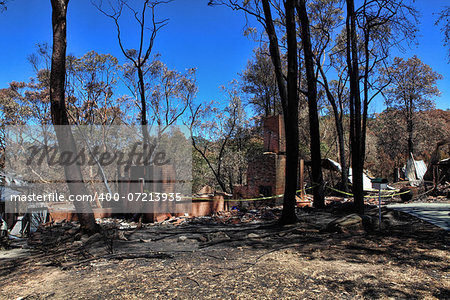 Houses caught up in bushfires have been razed to the ground, while others were spared.