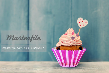 Photo of cute cupcake on wooden background