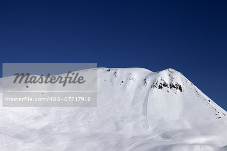 Off-piste slope with trace of skis, snowboarding and avalanche. Caucasus Mountains, Georgia, ski resort Gudauri.