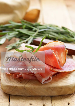 parma ham (jamon) sliced ??on a wooden board
