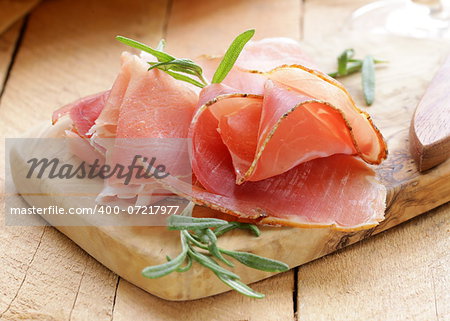 parma ham (jamon) sliced ??on a wooden board