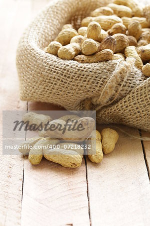 peanuts nuts  in a bag on wooden table