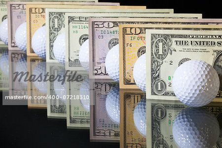 White golf balls and US dollars banknotes