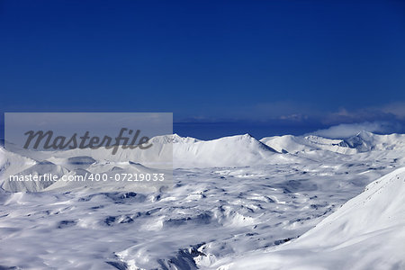Snowy plateau and off-piste slope at sun day. Caucasus Mountains, Georgia, ski resort Gudauri.
