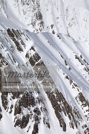 Snowy winter rocks. Caucasus Mountains, Georgia, view from ski resort Gudauri.