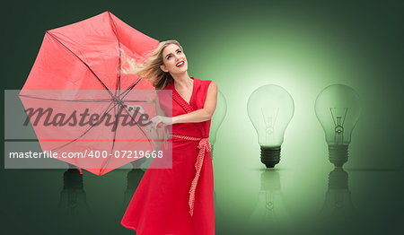 Composite image of elegant happy blonde holding umbrella