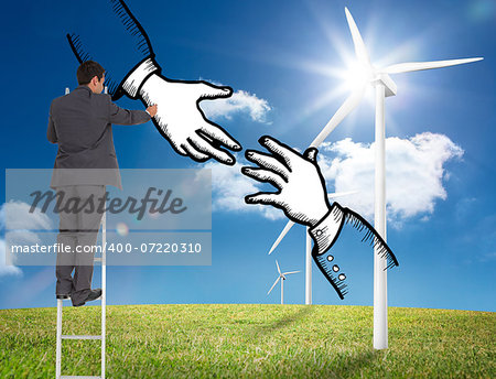 Composite image of businessman standing on ladder writing