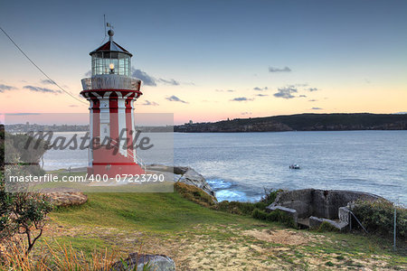 The beautiful red and white Hornby Lighthouse on South Head, Sydney Australia, the entrance to Sydney Harbour, at dawn.