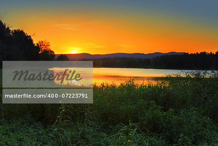 A view of the sun setting behind the famous Blue Mountains Australia, from lagoon at Agnes Banks.  Although a public reserve and recreation area, ithe 78 ha site is also a conservation zone and wildlife refuge