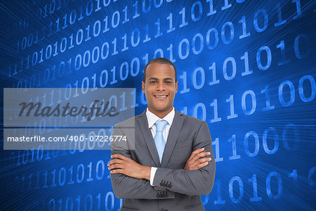 Composite image of charismatic young businessman with arms crossed