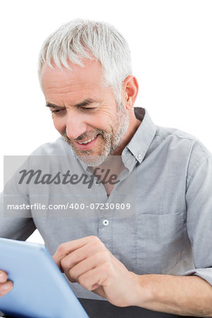 Mature businessman using digital tablet against white background