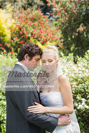 Romantic newlyweds embracing in the countryside