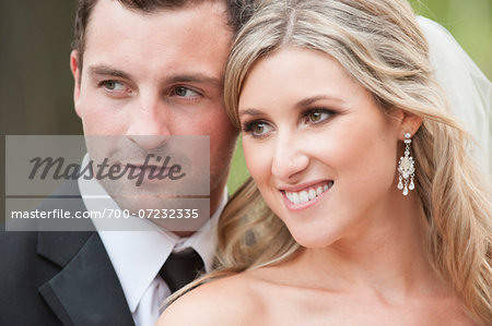 Close-up portrait of bride and groom smiling outdoors on Wedding Day, Canada