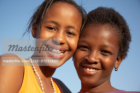 Two girls smiling, close-up