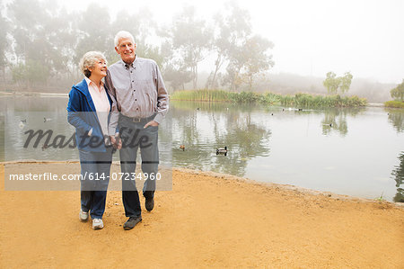 Husband and wife strolling by the lake