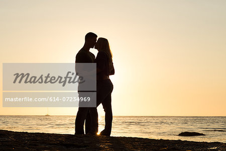 Silhouette of young couple kissing, Sunset Cliffs, San Diego, California, USA