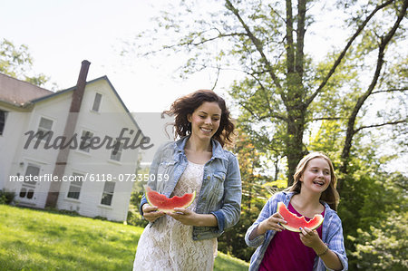 A family summer gathering at a farm. A shared meal, a homecoming. A family summer gathering at a farm. A shared meal, a homecoming.