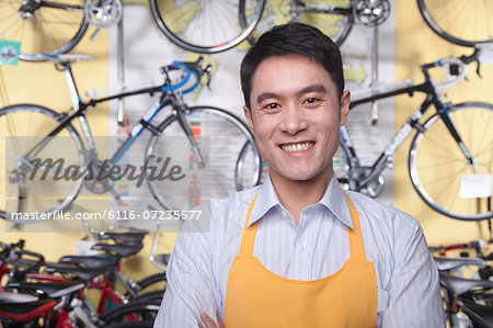 Portrait of young male mechanic in bicycle store, Beijing