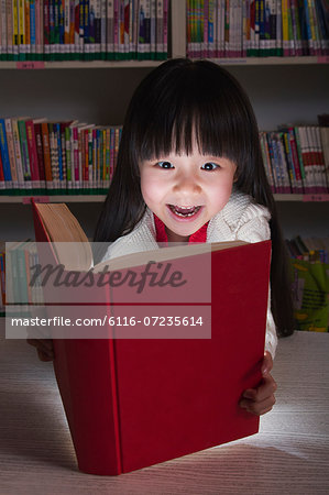 Girl Surprised By Glowing Book