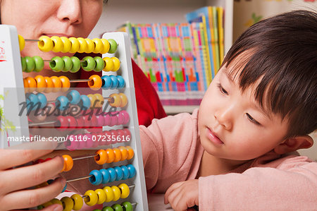 Boy Playing with Abacus