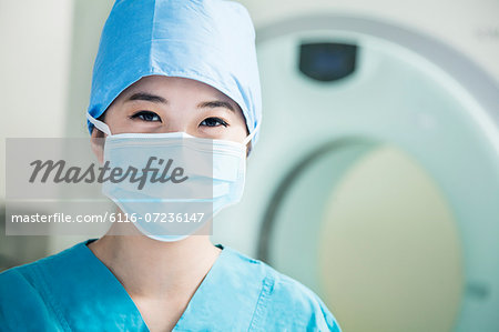 Portrait of young female surgeon wearing surgical mask in the operating room