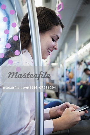 Young businesswoman sitting on the subway and using her phone Young businesswoman sitting on the subway and using her phone