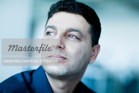 Portrait of businessman looking away in contemplation