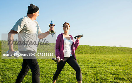 Man and Woman Lifting Weights Outdoors, Baden-Wurttemberg, Germany