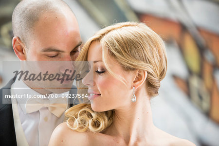 Close-up portrait of bride and groom looking at each other outdoors on Wedding Day, Canada