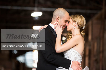 Bride and groom embracing at wedding venue on Wedding Day, Canada
