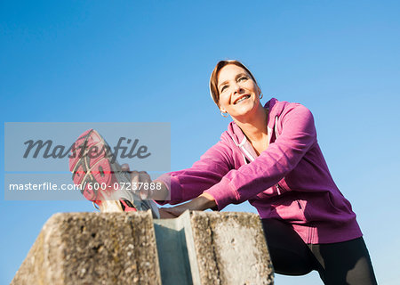 Mature Woman Stretching Outdoors, Mannheim, Baden-Wurttemberg, Germany