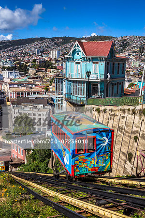 View of houses and colorful cable car on funicular railway, Valparaiso, Chile