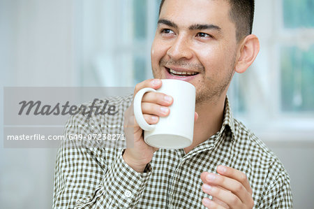 Mid adult man having coffee