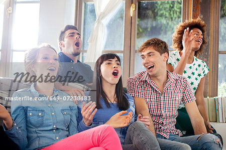 Five friends watching television