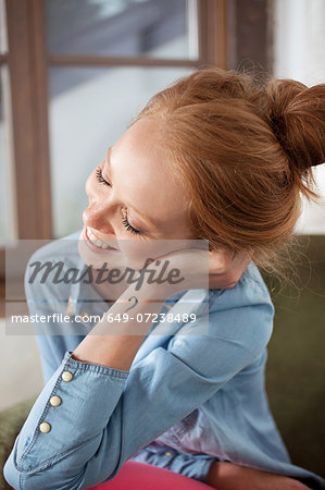 Young woman with question mark tattoo smiling